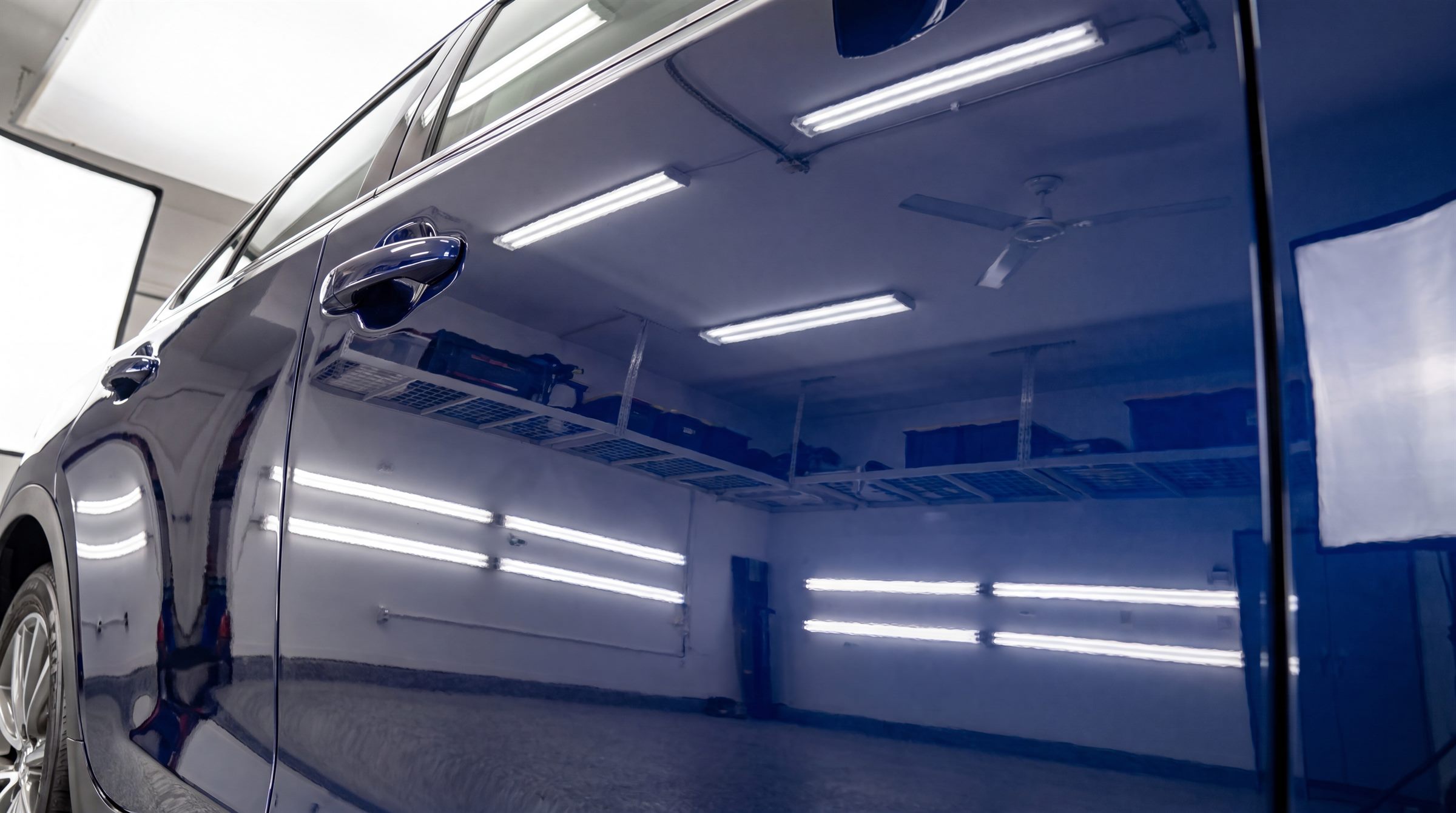 Mirror-like reflections on a freshly polished navy blue door panel