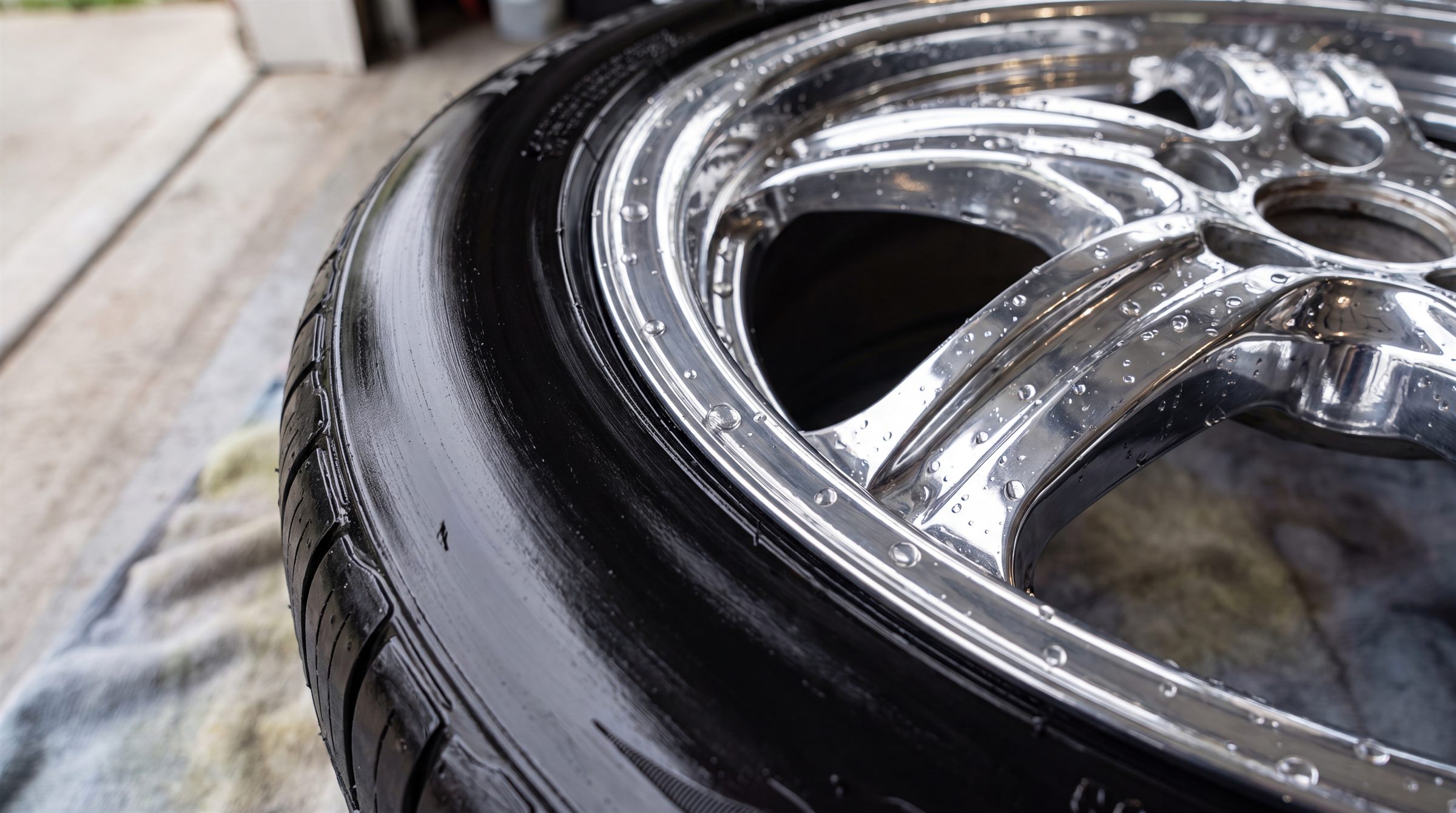 Chrome wheel gleaming with water droplets after a deep clean